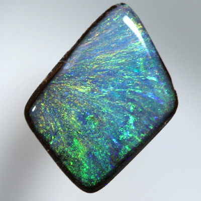 SOLID BOULDER OPAL Bright orange and green sparkles over blue